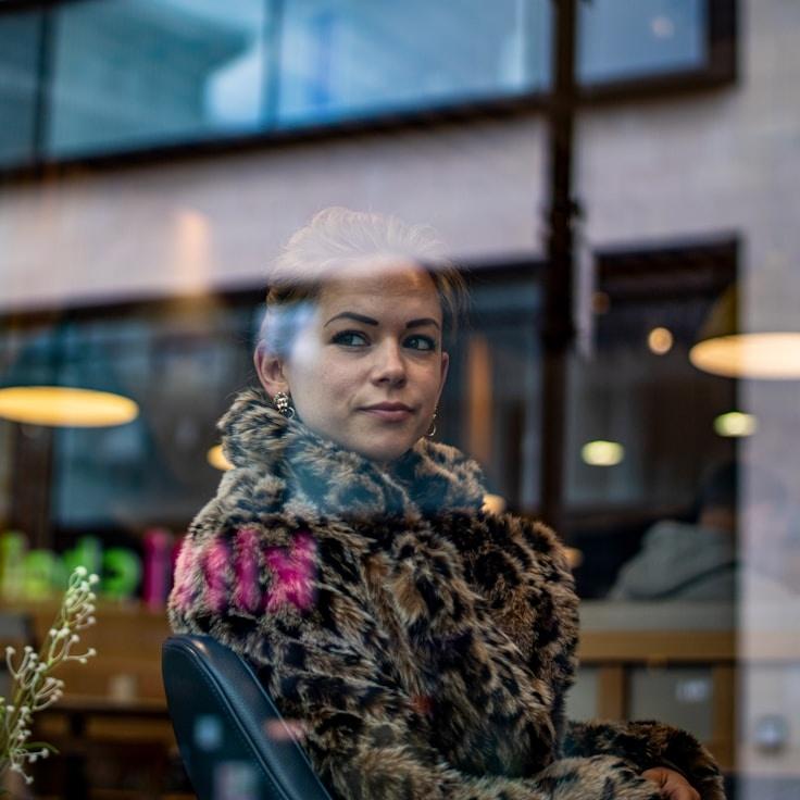 Avery Chen, Lead Design Curator at Stone Bridge Stone, reviewing corporate floral arrangements
